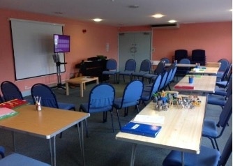 Table set-up with trays, folders, visual timetables, and sensory aids